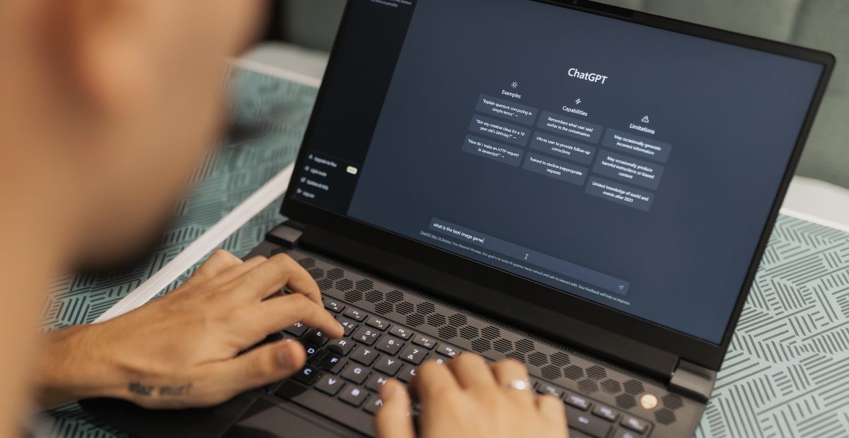 What-is-ChatGPT? Fingers of a man using ChatGPT on his laptop trying to use chatgpt for business
